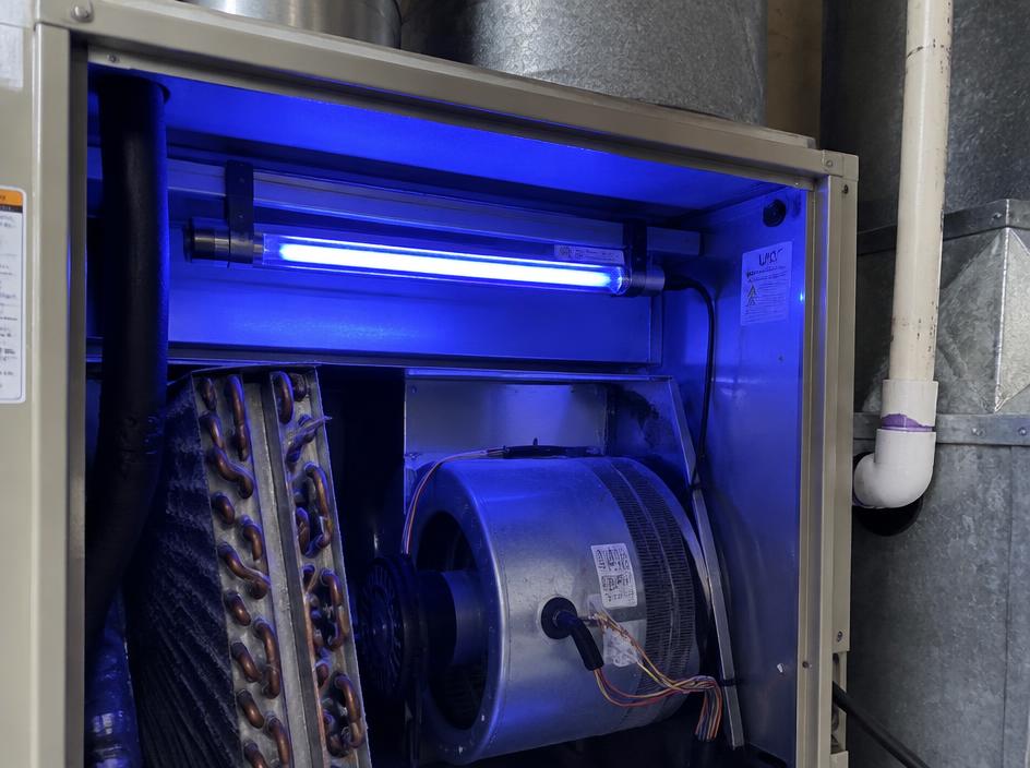 UV germicidal light glowing inside a furnace air handler