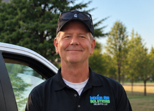 Indoor Air Solutions Unlimited technician by the work truck